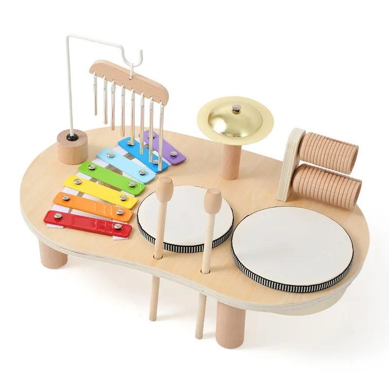 Wooden all-in-one music discovery center featuring xylophone, chimes, and drums for toddlers.