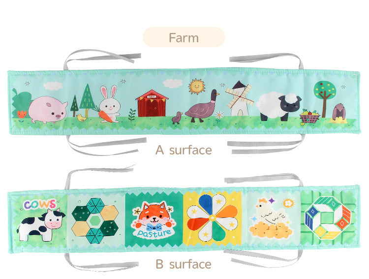 Newborn baby looking at a double-sided contrast book attached to the crib for visual development