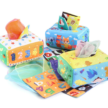Baby spielt mit einem Montessori-inspirierten sensorischen Taschentuchbox-Spielzeug und fördert dabei feinmotorische Fähigkeiten sowie visuelle Konzentration.