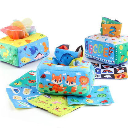 Baby spielt mit einem montessori-inspirierten sensorischen Taschentuchbox-Spielzeug und entwickelt feinmotorische Fähigkeiten sowie die visuelle Konzentration