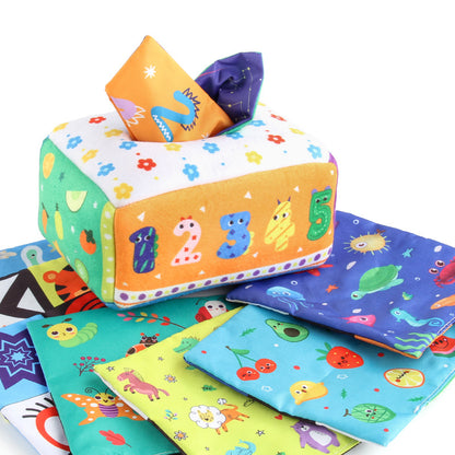 Baby spielt mit einem montessori-inspirierten sensorischen Taschentuchbox-Spielzeug und fördert feinmotorische Fähigkeiten sowie visuelle Konzentration