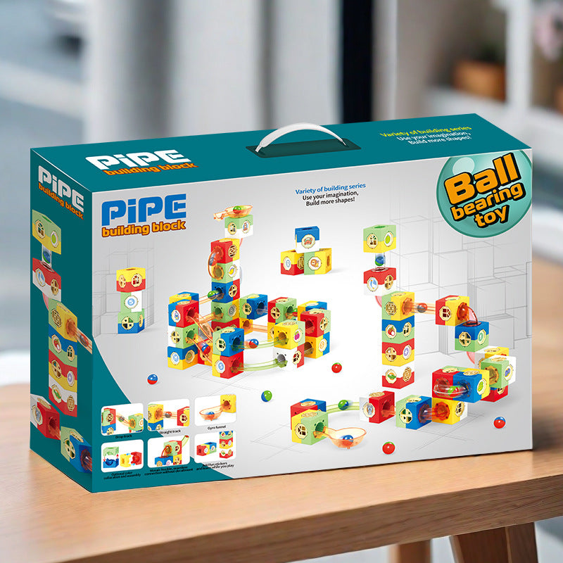 Kinder spielen mit einem magnetischen Murmelbahn-Set und bauen bunte Rohrleitungen und Tunnel
