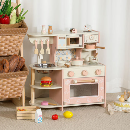 Little Chef's Dreamland pink wooden toy kitchen set for kids, featuring a sink, stove, microwave, and storage shelf.